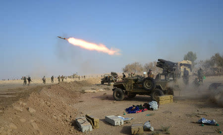 Popular Mobilization Forces (PMF) launch a rocket during clashes with Islamic State militants on the outskirts of the town of Hammam Al-Alil in the south of Mosul, Iraq October 30, 2016. REUTERS/Stringer