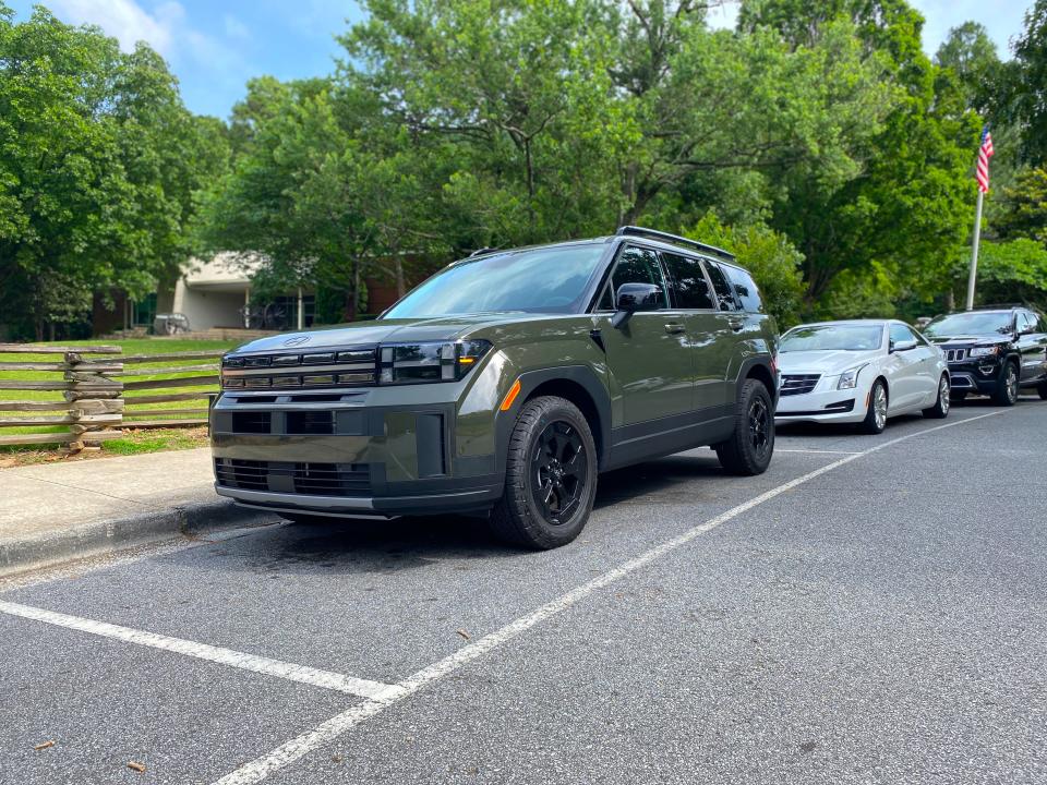 A green 2024 Hyundai Santa Fe XRT SUV parked at a park.