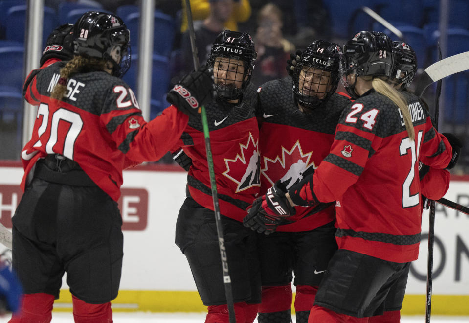 Canada's Renata Fast (14) celebrates her goal over Czechia with teammates during the second period of a hockey match at the IIHF Women's World Championships in Utica, N.Y., Sunday, April 7, 2024.(Christinne Muschi/The Canadian Press via AP)