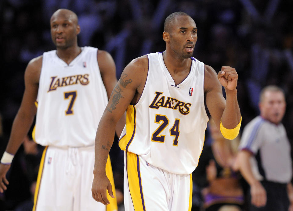 Los Angeles Lakers guard Kobe Bryant (24) reacts after scoring in the closing minutes of the second half of an NBA basketball game against the Houston Rockets, Sunday, Nov. 9, 2008, in Los Angeles. At left is Lakers forward Lamar Odom. (AP Photo/Mark J. Terrill)