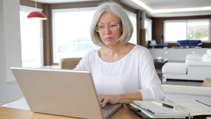 Senior woman using laptop at home