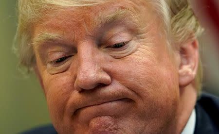 U.S. President Donald Trump looks down while speaking to reporters about healthcare during an energy policy discussion with leaders of American Indian tribes and U.S. governors at the White House in Washington, U.S., June 28, 2017. REUTERS/Kevin Lamarque/Files