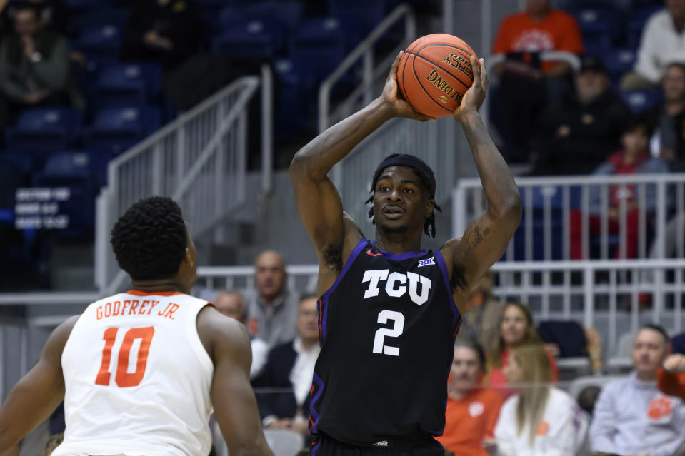TCU forward Emanuel Miller (2) looks for a play while defended by Clemson forward RJ Godfrey (10) during first-half NCAA college basketball game action of the Hall of Fame Series in Toronto, Saturday, Dec. 9, 2023. (Christopher Katsarov/The Canadian Press via AP)