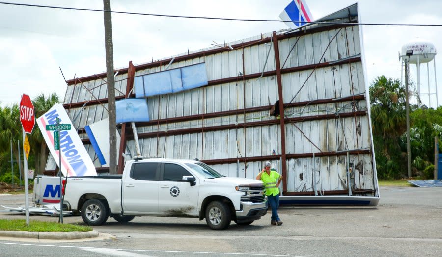 A Levy County road worker parks at a destroyed Marathon gas station on Wednesday, Aug. 30, 2023, in Cedar Key, Fla., after Hurricane Idalia passed through. (Douglas R. Clifford/Tampa Bay Times via AP)