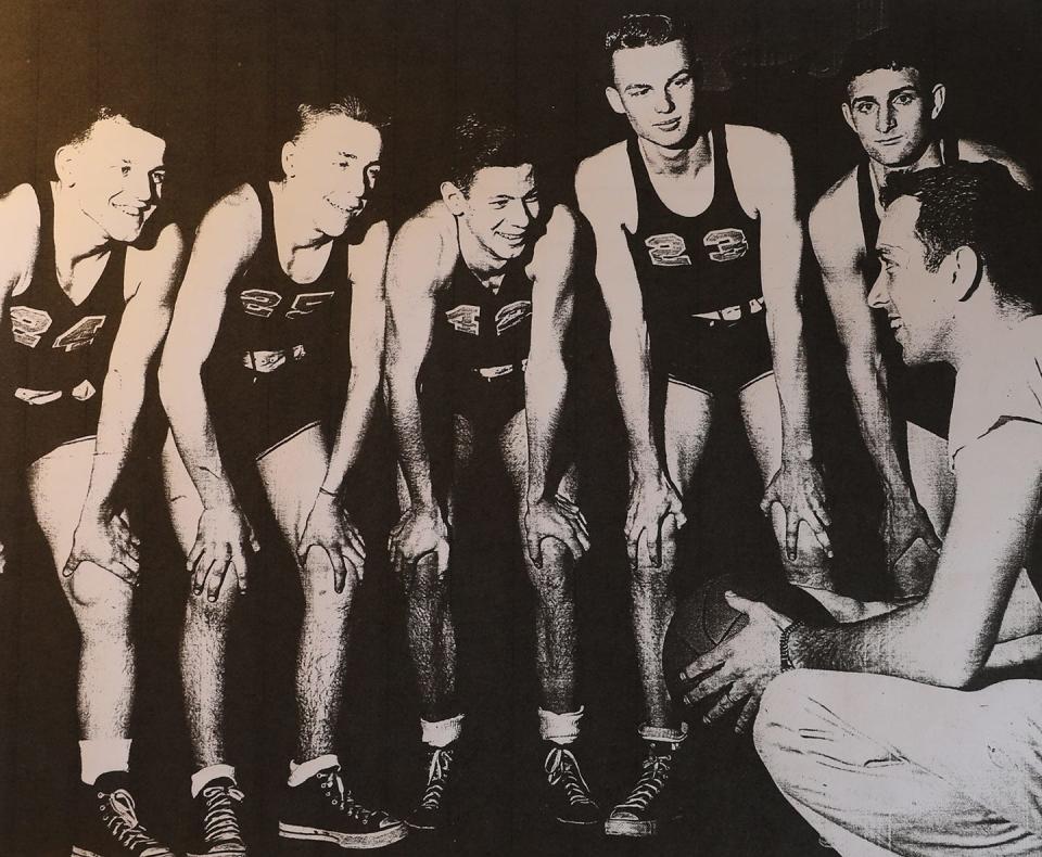 ROVA coach Jim Pogue gives instructions to five of his team members from the 1948-49 team. From left are Clark Main, Jim Asplund, Bob Seiler, Harley Pearson and Dean Truelove.