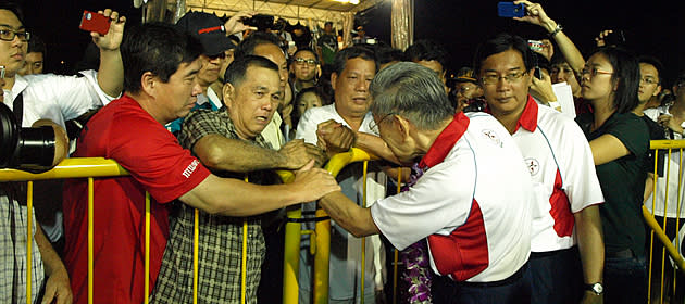 An ardent supporter breaks down upon meeting Mr Chiam See Tong, clutching both his hands and giving the latter his best wishes. (Yahoo! photo/Christine)