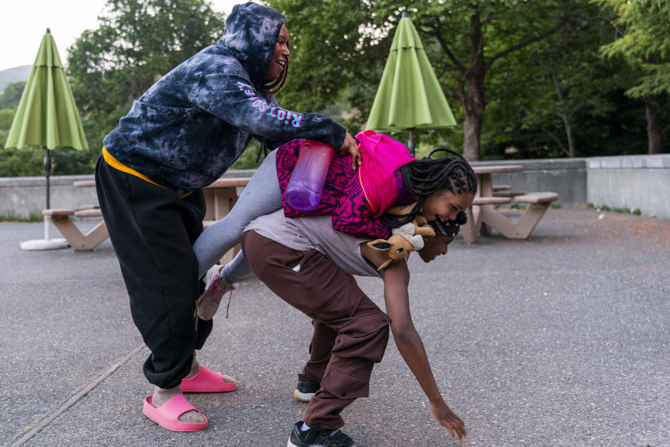 Counselors Satya Sheftel-Gomes, 22, of San Francisco, left, and Kenya Edelhart, 21, of Simi Valley, Calif., who have attended the camp since they were 11 and 6 respectively, joke with Kallie House, 12, of Sugar Land, Texas, on the way to a camper talent show during Camp Be’chol Lashon, a sleepaway camp for Jewish children of color, Friday, July 28, 2023, in Petaluma, Calif., at Walker Creek Ranch. “As a small child, I was constantly in Ashkenazi Jewish conversations without any conversation about my being Black,” says Sheftel-Gomes, speaking of Jewish people of Eastern European descent, “It was this is my granddaughter, as such she belongs here. I would have to figure out my difference on my own. That’s part of why camp is so important, to give me the language to identify what I was experiencing without knowing why. I learned what it was for me to be Black at Camp Be’chol Lashon.” (AP Photo/Jacquelyn Martin)