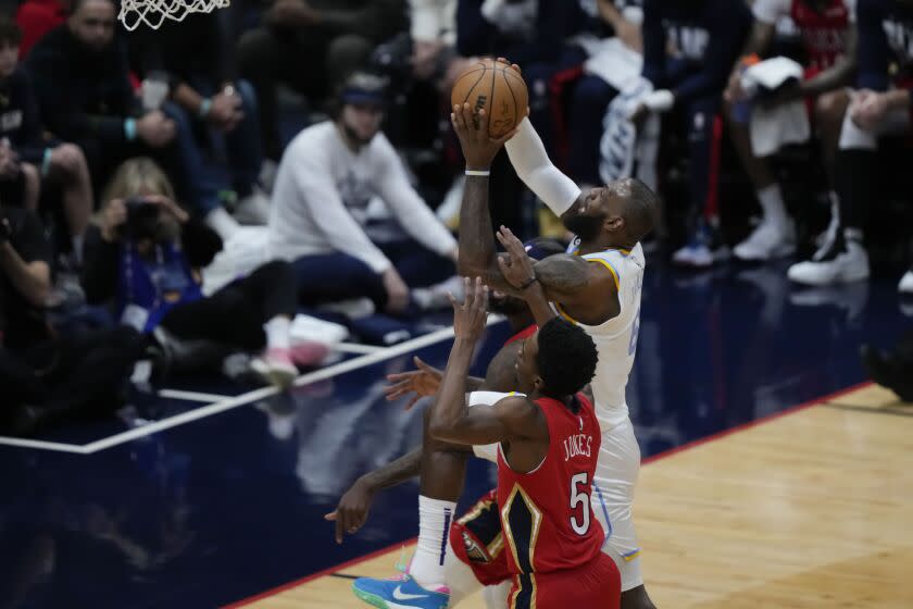 Los Angeles Lakers forward LeBron James (6) goes to the basket against New Orleans Pelicans forward Herbert Jones (5) in the first half of an NBA basketball game in New Orleans, Saturday, Feb.  4, 2023. (AP Photo/Gerald Herbert)