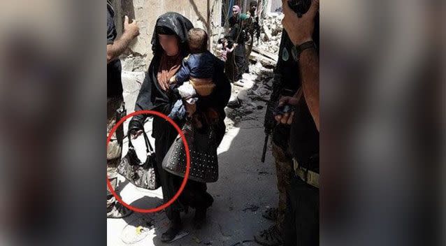 A chilling photo of a female suicide bomber holding her baby moments before she pressed the detonator has emerged. Photo: Al-Mawsleya TV