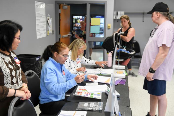 Poll workers check-in voters for the statewide primary election on Tuesday, June 7, 2022, at Kenny Anderson Community Center in Sioux Falls, S.D.