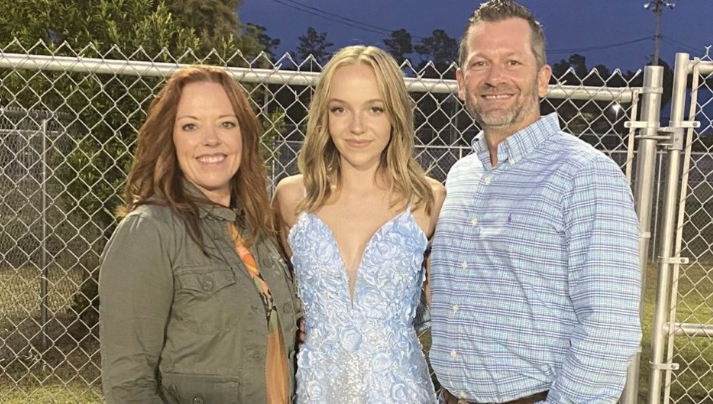 Addison Bethea, center, poses for a photo with her parents, Michelle Murphy, left, and Shane Bethea, right.