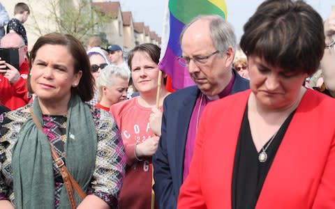 Sinn Fein Leader Mary Lou McDonald (left), DUP leader Arlene Foster (right) with Sara Canning (centre), the partner of 29-year-old journalist Lyra McKee, at a vigil in Londonderry - Credit: Brian Lawless/PA Wire