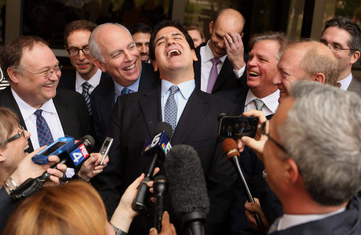 Mark Cuban, billionaire owner of the NBA Dallas Mavericks basketball team, center, laughs while speaking to the media after exiting federal court in Dallas, Texas, U.S., on Wednesday, Oct. 16, 2013. Cuban didn't engage in insider trading nine years ago, a federal jury decided in a case brought by the U.S. Securities and Exchange Commission (SEC). Photographer: Mike Fuentes/Bloomberg via Getty Images 