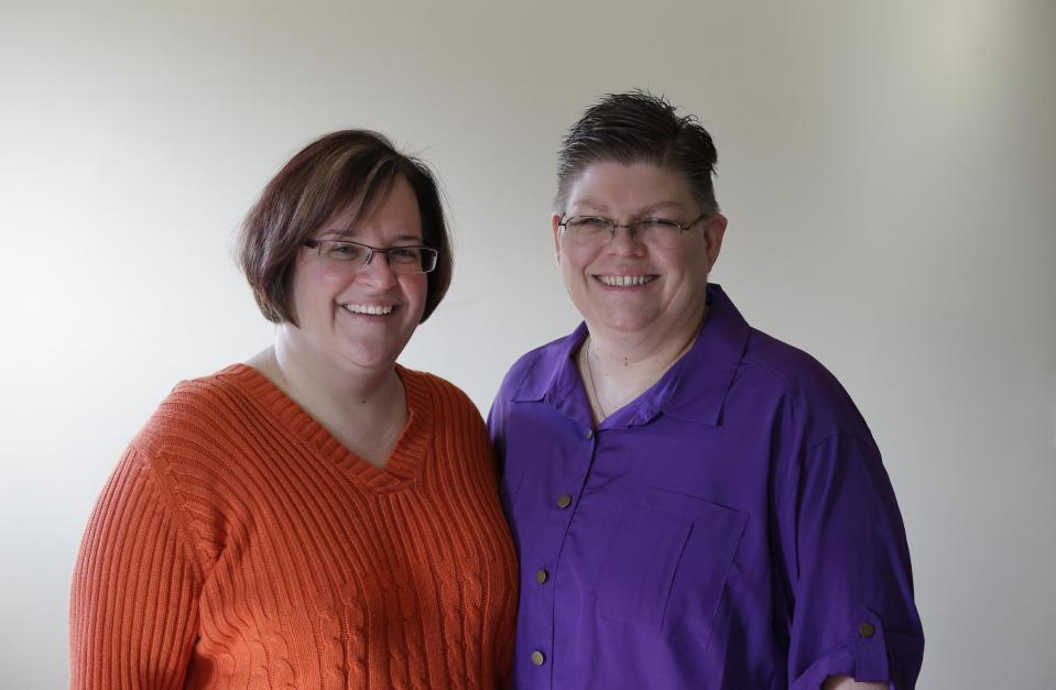 FILE - In this March 5, 2013, file photo, April DeBoer, left, and Jayne Rowse pose at their home in Hazel Park, Mich. A federal judge has struck down Michigan's ban on gay marriage Friday, March 21, 2014, the latest in a series of decisions overturning similar laws across the U.S. The two nurses who've been partners for eight years claimed the ban violated their rights under the U.S. Constitution. (AP Photo/Paul Sancya, File)