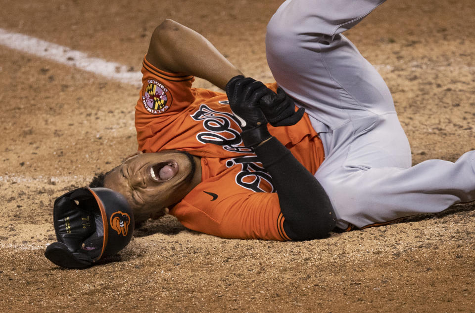 Baltimore Orioles' Pedro Severino (28) grimaces as he falls to the ground after getting hit by a pitch during the ninth inning of the team's baseball game against the Washington Nationals in Washington, Saturday, Aug. 8, 2020. The Orioles won 5-3. (AP Photo/Manuel Balce Ceneta)