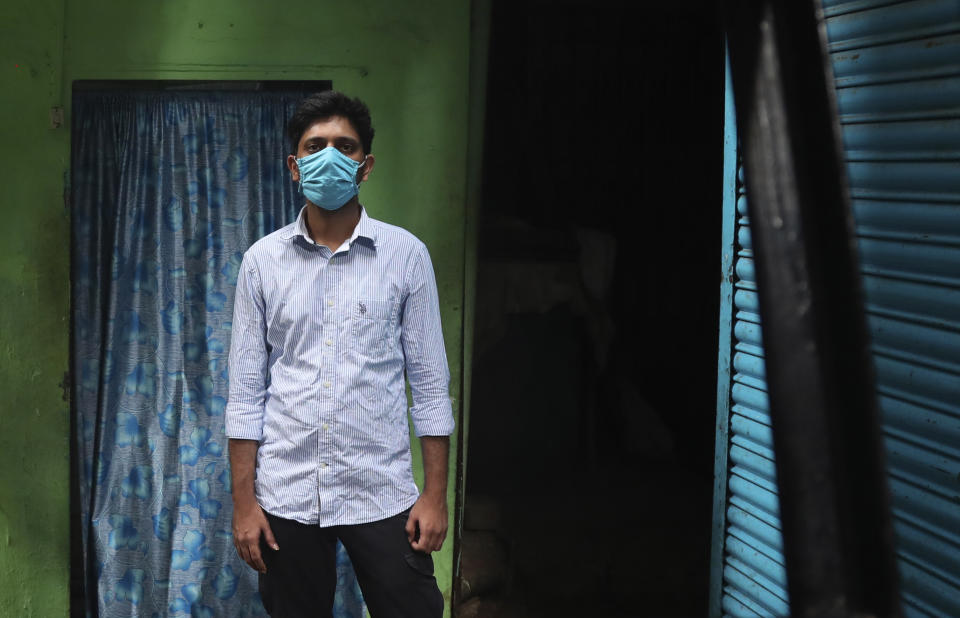 Community activist Kunal Kanase, 31, stands for a picture in a lane of Dharavi, one of Asia's largest slums, in Mumbai, India, Saturday, May 16, 2020. Kanase is among many unsung heroes working to protect some of India’s most vulnerable people from the ravages of the coronavirus and the economically devastating nationwide lockdown that has left millions unable to feed themselves. (AP Photo/Rafiq Maqbool)