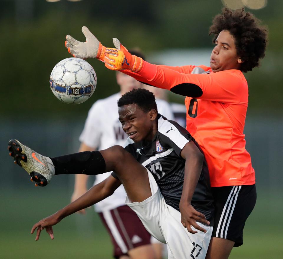 Appleton West High School's Lomona Ilunga (17) tries to score a goal against Winneconne High School's Malik Jenns (0) during their boys soccer game Tuesday, August 30, 2022, in Appleton, Wis. West won 5-0.