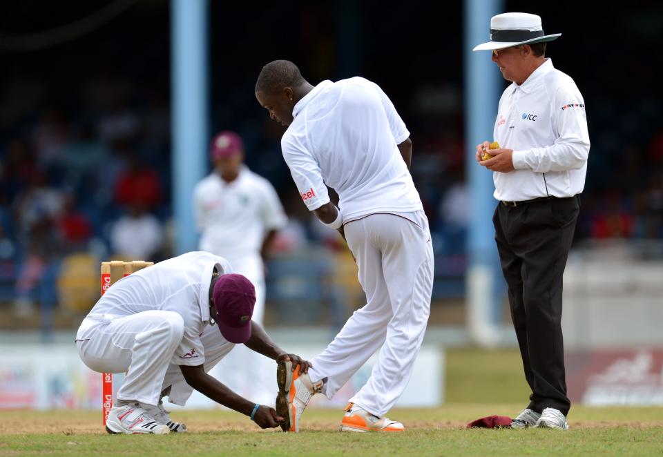 West Indies bowler Fidel Edwards (C) get