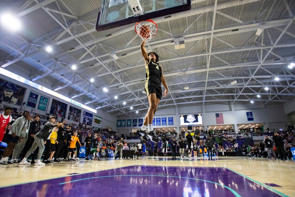 Paul VI Panthers guard Isaiah Abraham (4) dunks after jumping from the free throw line during the 50th annual City of Palms Classic dunk contest at Suncoast Credit Union Arena in Fort Myers on Wednesday, Dec. 20, 2023.