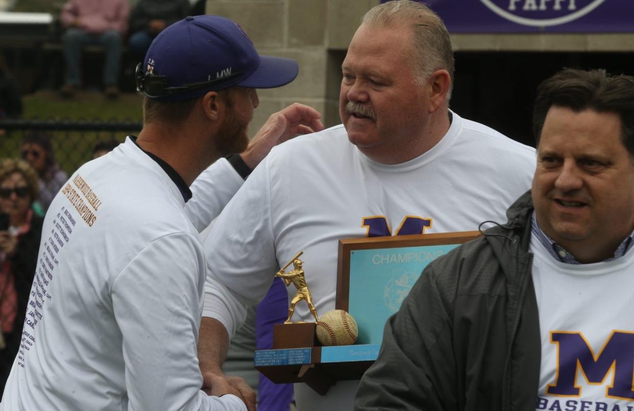 Marshwood High School baseball coach Eric Wells greeting former Hawks player Rheinhold Holton, with Marc Schoff also pictured, during Marshwood's 12-5 win over Noble on Saturday at Marshwood High School.