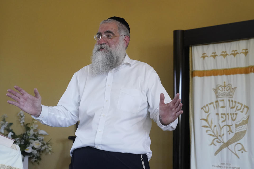 Rabbi Yitzchok Minkowicz speaks inside the Chabad Lubavitch of Southwest Florida Monday, Oct. 3, 2022, in Fort Myers, Fla. The synagogue has been transformed into a full-fledged community center with food trucks and a pantry. They are planning to celebrate Yom Kippur on Tuesday. (AP Photo/Marta Lavandier)