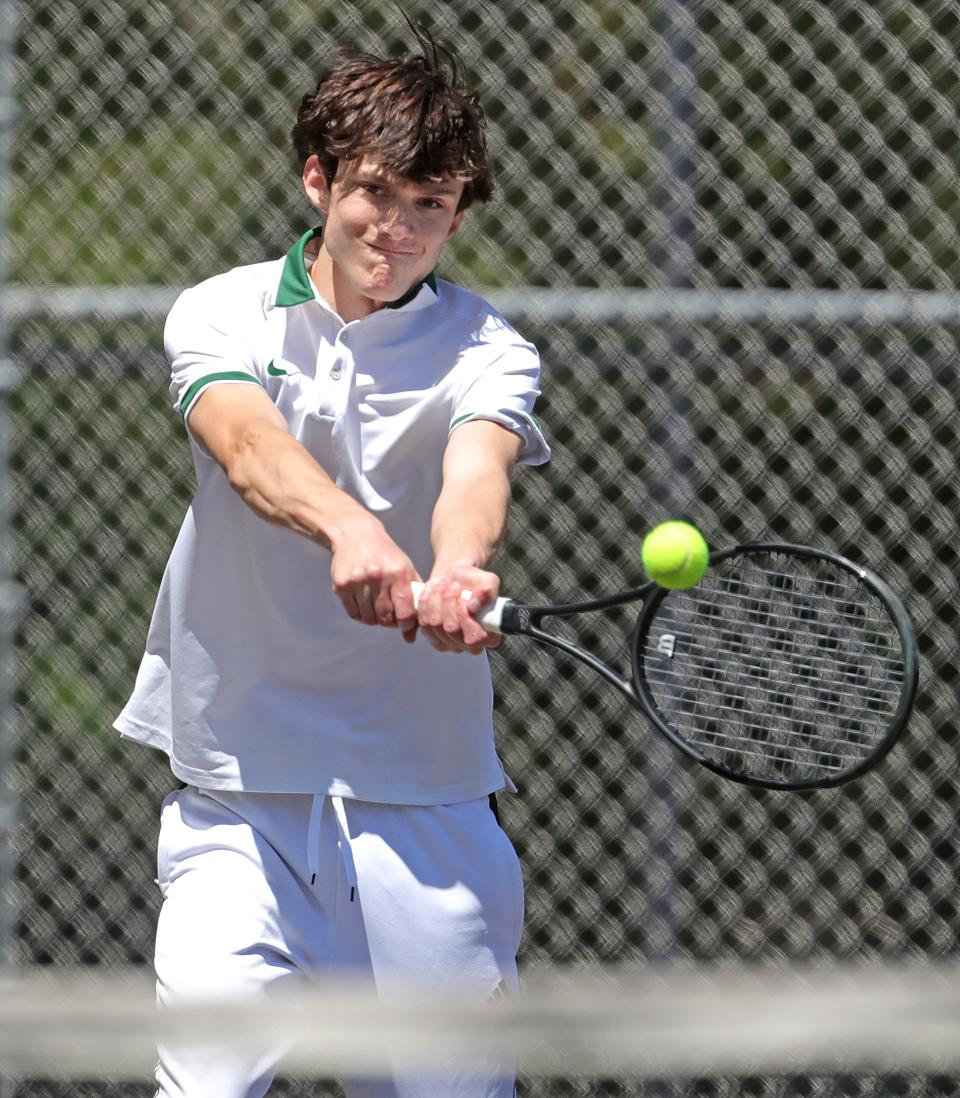 Firestone's Reece Caraboolad returns a serve in a match against North's Sanjil Magar in the City Series Tennis Tournament on Monday at Hyre Park. Caraboolad went on to win the singles title and led the Falcons to the team title.