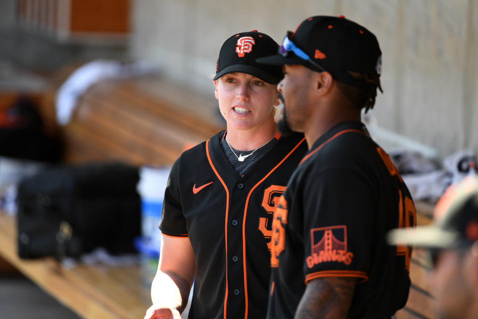 Assistant coach Alyssa Nakken #92 of the San Francisco Giants talks with Jaylin Davis #49 in the dugout prior to a spring training game against the Milwaukee Brewers at American Family Fields of Phoenix on March 06, 2020 in Maryvale, Arizona. (Photo by Norm Hall/Getty Images)