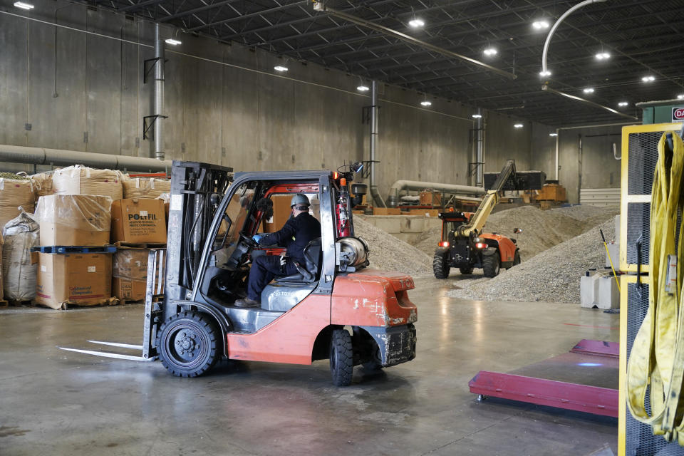 An operator moves a fork lift into position at Alterra Energy to move pallets of stored ground up plastics the company receives from recycling facilities to their facility in Akron, Ohio on Thursday, Sept. 8, 2022. The U.S. facilities currently recycling plastic into new plastic are small — the largest is the 60-ton-per-day plant Alterra Energy, according to the ACC. (AP Photo/Keith Srakocic)