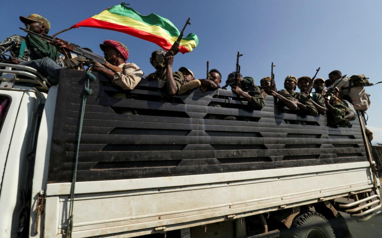 Members of Amhara region militias ride on theri way to fight the Tigray People's Liberation Front in Sanja - TIKSA NEGERI /REUTERS 