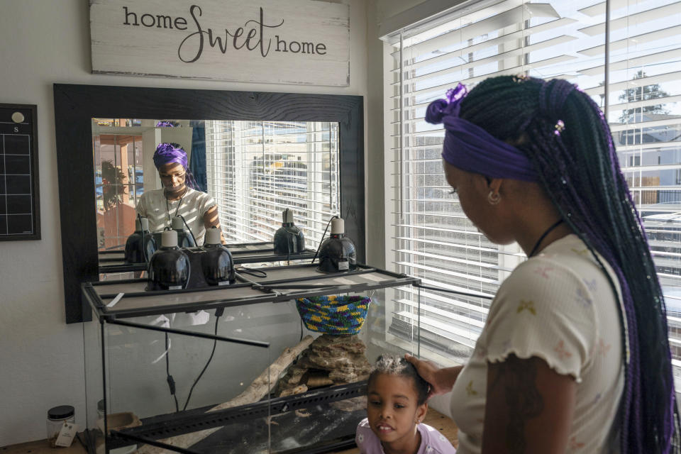 Christina Engram spends time at home with daughter, Neveah, 6, in Oakland, Calif., on Friday Nov. 24, 2023. (AP Photo/Loren Elliott)