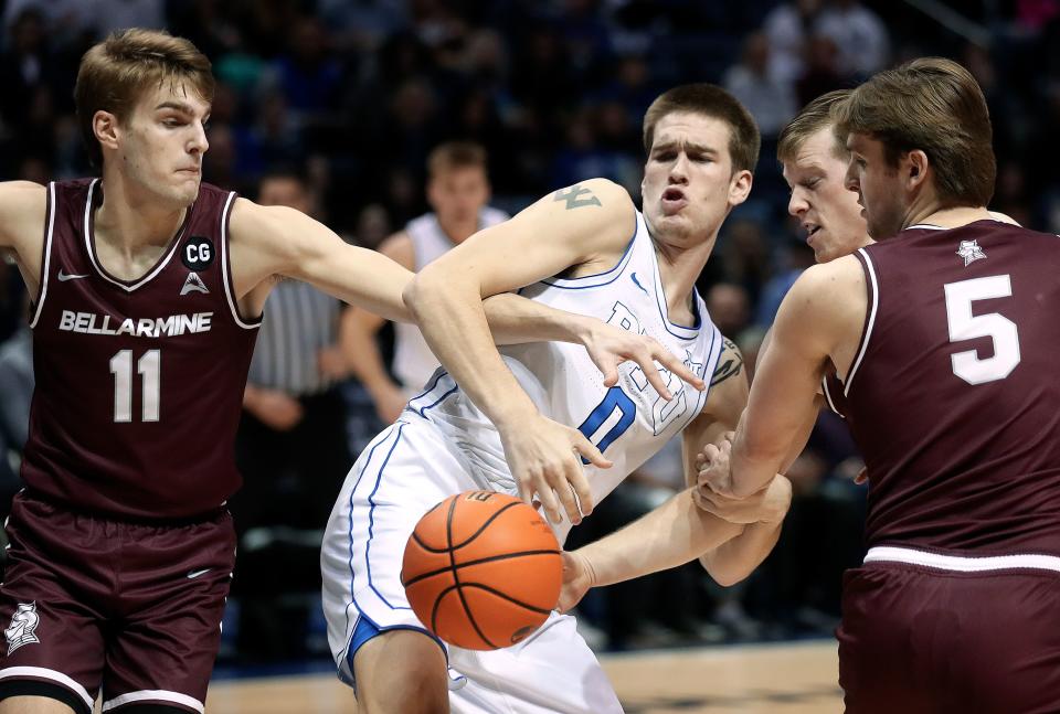 Bellarmine Knights guard Billy Smith (11), Brigham Young Cougars forward Noah Waterman (0), Bellarmine Knights guard Garrett Tipton (10) and Bellarmine Knights guard Peter Suder (5) fight for the ball during a men’s basketball game at the Marriott Center in Provo on Friday, Dec. 22, 2023. BYU won 101-59. | Kristin Murphy, Deseret News