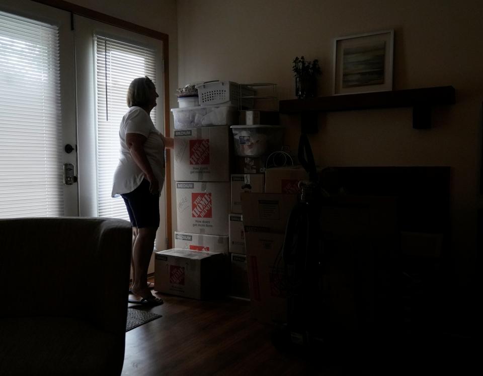 May 1, 2024; Columbus, Ohio, USA; 
Kathy Bird looks over moving boxes inside the townhome she rents on Griggsview Court in the Walden Woods neighborhood near Hilliard. Residents say that Peak Property Group purchased the complex and is forcing them to move out so that the units can be updated and rented for higher prices.