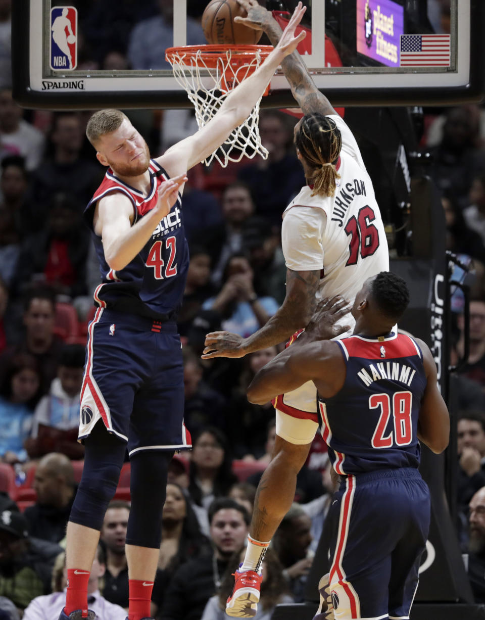 Miami Heat forward James Johnson (16) shoots over Washington Wizards forward Davis Bertans (42) and center Ian Mahinmi (28) during the first half of an NBA basketball game, Wednesday, Jan. 22, 2020, in Miami. (AP Photo/Lynne Sladky)