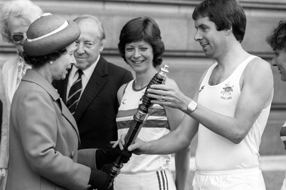 The Queen hands the baton for the Commonwealth Games relay to Brendan Foster (PA) (PA Archive)