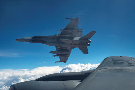 FILE PHOTO: Royal Canadian Air Force CF-18 Hornets depart after refueling with a KC-135 Stratotanker assigned to the 340th Expeditionary Air Refueling Squadron over Iraq October 30, 2014. REUTERS/U.S. Air Force/Staff Sgt. Perry Aston/Handout via Reuters/File Photo