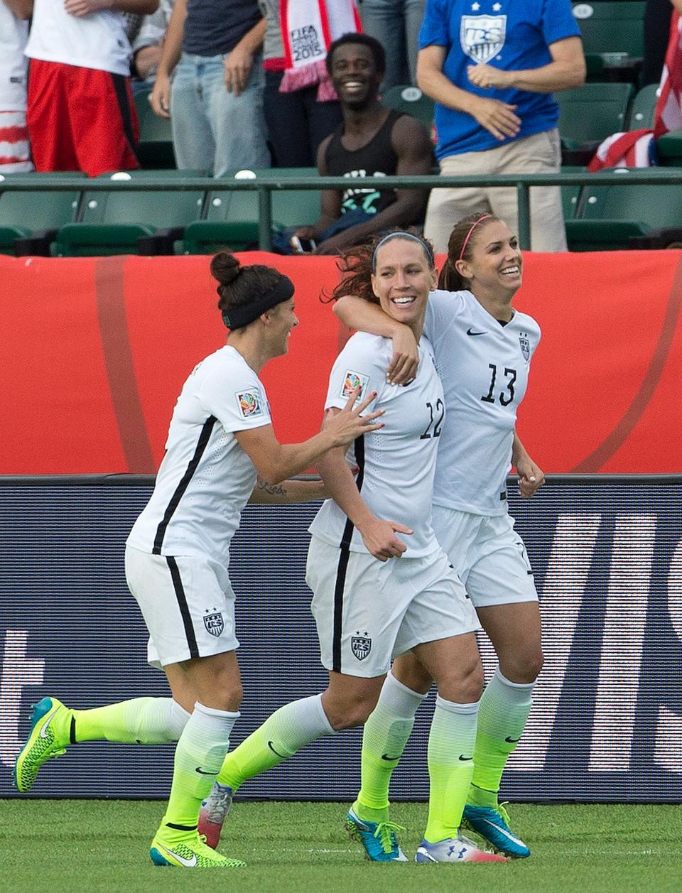 Lauren Holiday (12) celebrates with Ali Krieger (11) and Alex Morgan (13) against Colombia in the second half of a Round of 16 game in the FIFA Women's World Cup on June 22, 2015. The USWNT won the gold medal and Holiday scored a goal in the final against Japan.