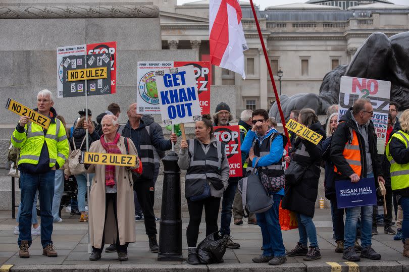 Protesters hold placards and flag during a anti-ULEZ expansion demonstration on the Trafalgar Square