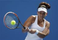 Casey Dellacqua of Australia hits a return to Kirsten Flipkens of Belgium during their women's singles match at the Australian Open 2014 tennis tournament in Melbourne January 15, 2014. REUTERS/Bobby Yip