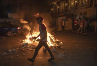 Angry demonstrators set fires, block the streets of the city center and clash with riot police following the death of Nizar Banat, an outspoken critic of the Palestinian Authority, in the West Bank city of Ramallah, Thursday, June 24, 2021. Banat who was a candidate in parliamentary elections called off earlier this year died after Palestinian security forces arrested him and beat him with batons on Thursday, his family said. (AP Photo/Nasser Nasser)