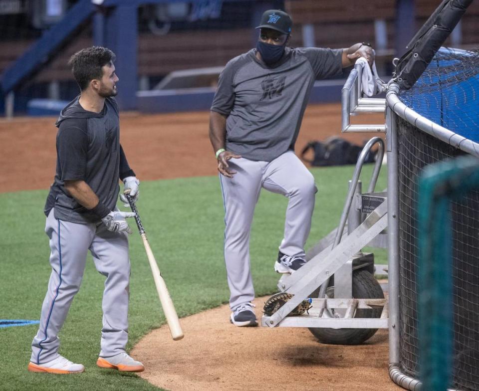 Miami Marlins infielder Eddy Alvarez talks with bench coach James Rowson during Marlins training camp at Marlins Park on Wednesday, July 8, 2020.