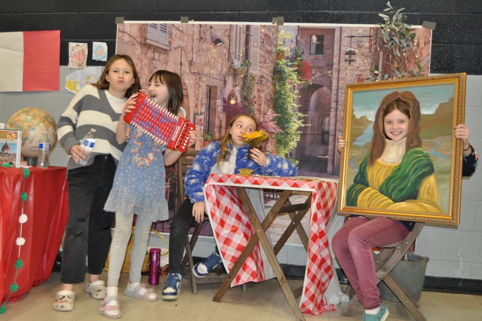 From left, Granville Girl Scouts Eliza Baldwin, Olive Moran, Makenzie Smith and Piper Gorney visit the Italy station during a March 19 Girl Scout event called  "Friendships Circle the World." The event was held in honor of Girl Scouts' 111 birthday, which was March 12.