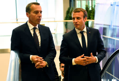 Austrian chancellor Christian Kern (L) and French President Emmanuel Macron arrive for a meeting at the Congress palace in Salzburg, Austria, August 23, 2017. REUTERS/Bertrand Guay