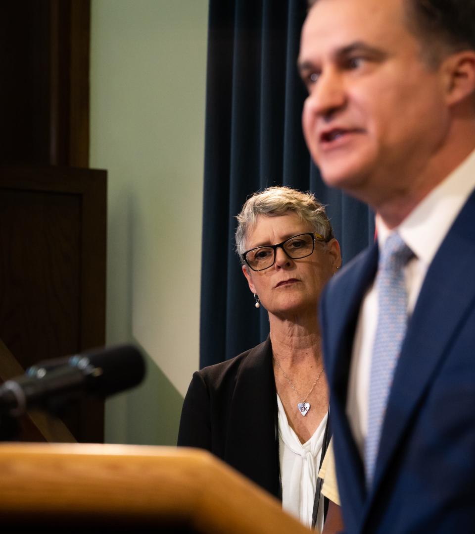 State Sen. Sarah Eckhardt listens to Sen. Roland Gutierrez as he announces five bills related to gun safety during a news conference at the Capitol on Monday, March 7, 2023.