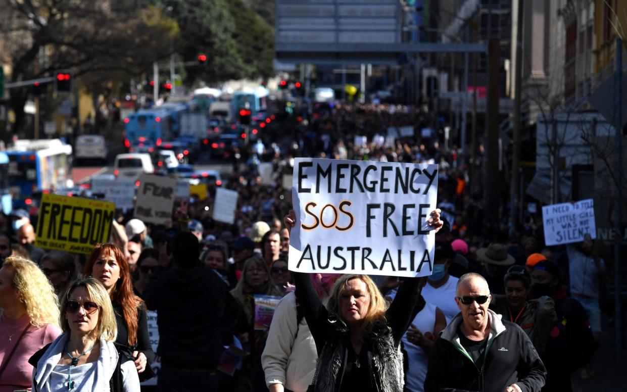 Protesters march through the city centre during an anti-lockdown rally as an outbreak of the coronavirus disease - Reuters