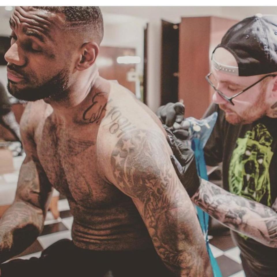 Basketball champ LeBron James sits as McCurdy inks him on his back. BangBangNYC/ Instagram