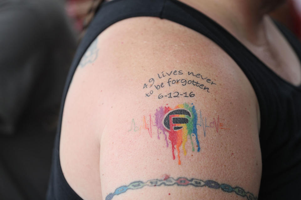 <p>A tattoo notes the loss of family, friends and loved ones in the mass shooting at the Pulse gay nightclub during the one-year anniversary memorial service at the club on June 12, 2017 in Orlando, Florida. (Joe Raedle/Getty Images) </p>