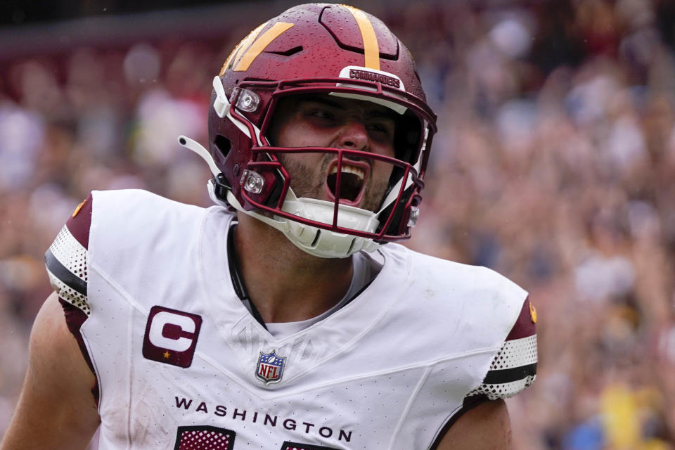 Sep 10, 2023; Landover, Maryland, USA; Washington Commanders quarterback Sam Howell (14) reacts after rushing for a touchdown against the <a class="link " href="https://sports.yahoo.com/nfl/teams/arizona/" data-i13n="sec:content-canvas;subsec:anchor_text;elm:context_link" data-ylk="slk:Arizona Cardinals;sec:content-canvas;subsec:anchor_text;elm:context_link;itc:0">Arizona Cardinals</a> at FedExField. Mandatory Credit: Brent Skeen-USA TODAY Sports