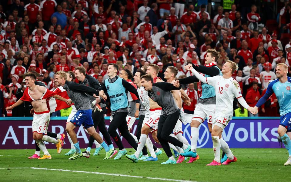 Denmark players celebrate in front of their fans following their 2-1 win over Russia in Copenhagen on Monday. The victory sets up a round of 16 meeting with Wales (Getty)