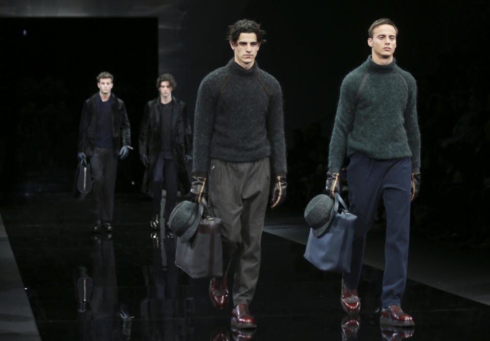 Models wear creations for Giorgio Armani men's Fall-Winter 2014 collection, part of the Milan Fashion Week, unveiled in Milan, Italy, Tuesday, Jan.14, 2014. (AP Photo/Luca Bruno)