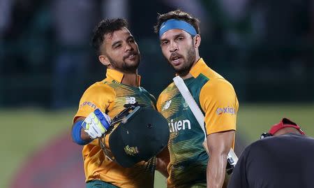 South Africa's Farhaan Behardien (R) and Jean-Paul Duminy celebrate their team's victory over India during their first Twenty-20 cricket match in the northern Indian hill town of Dharamsala, India, October 2, 2015. REUTERS/Adnan Abidi